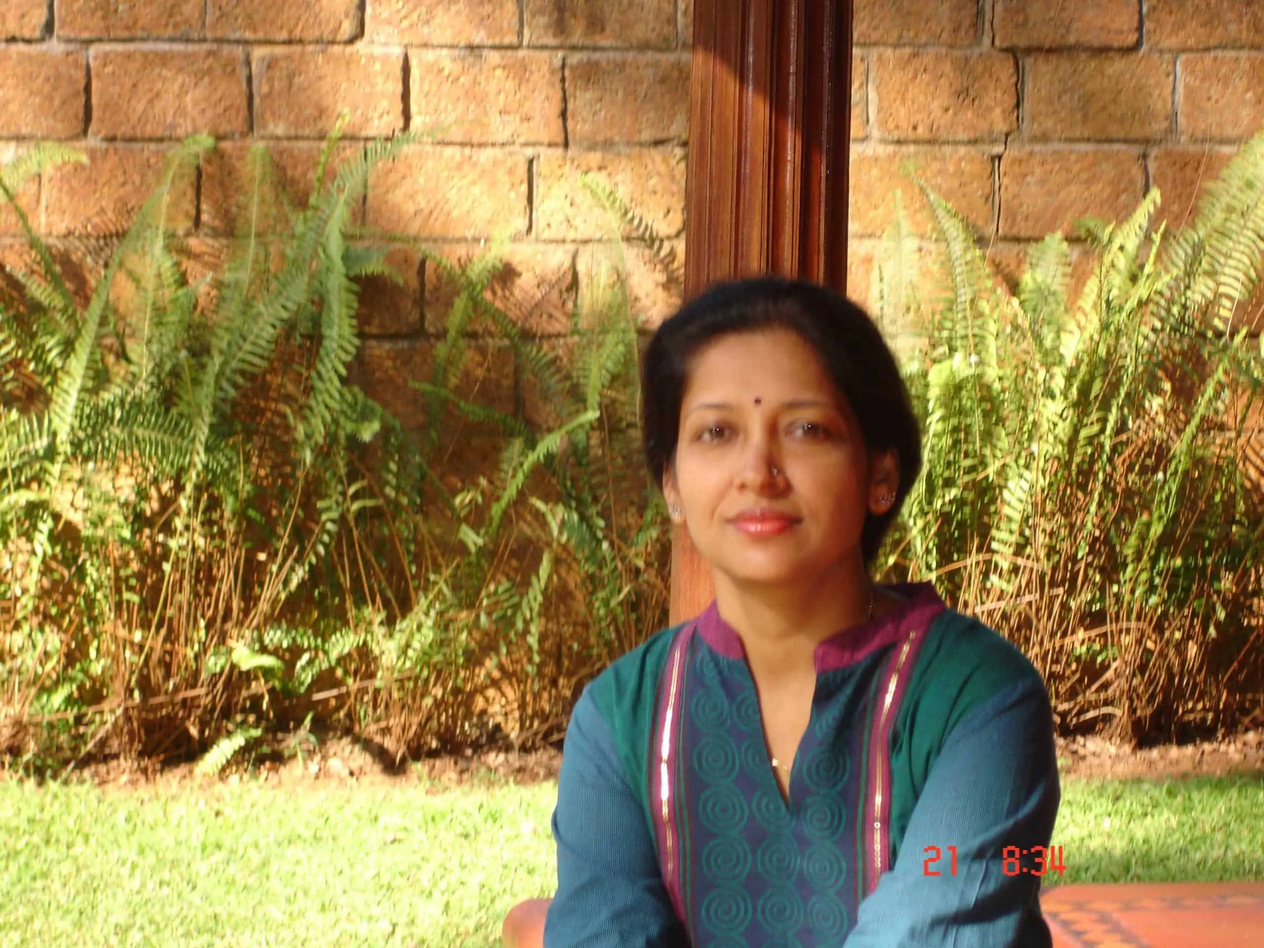 Jayashree preparing a vegetarian dish in her home kitchen
