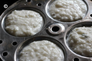 batter into the idli moulds