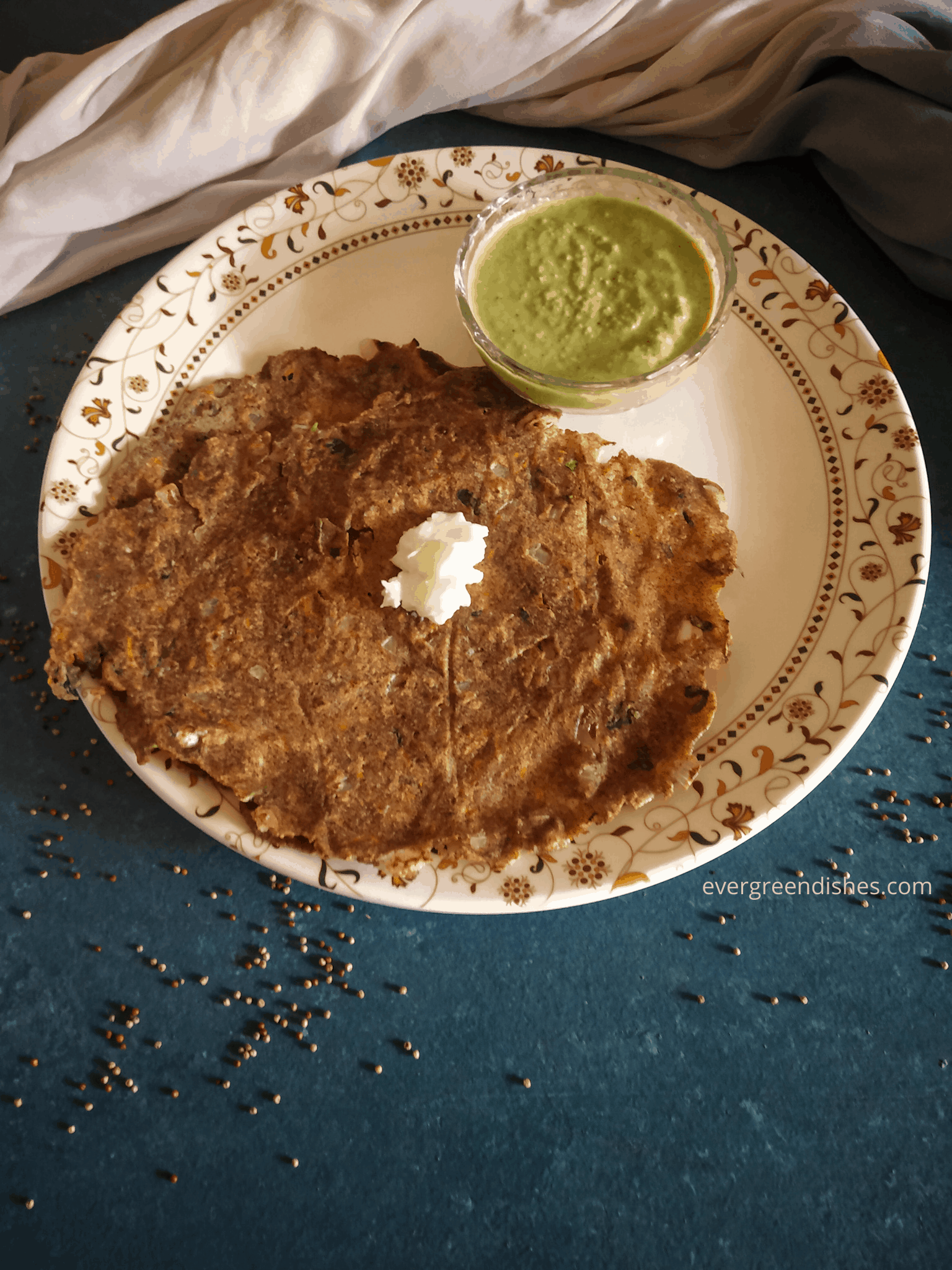 multi millet thalipeeth served with a dollop of butter and chutney